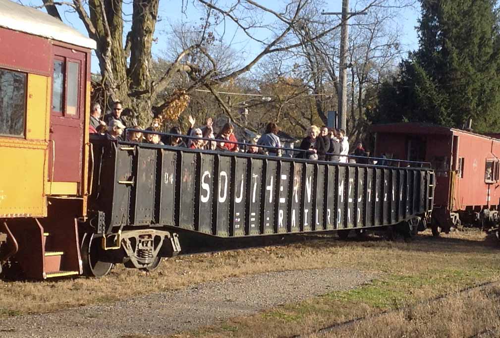 open-air car full of people